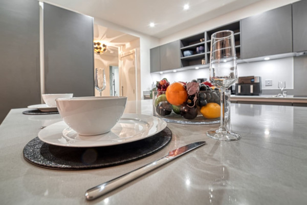 Close-up of a stylish Airbnb kitchen detail with cup and modern interior background.
