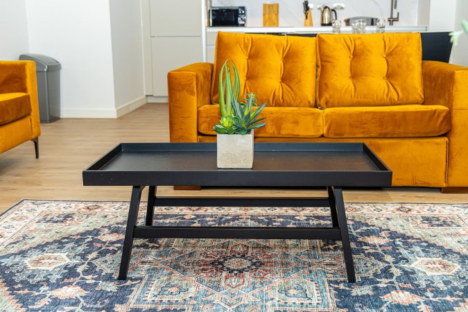 Bright Airbnb living room with comfortable sofa and coffee table.
