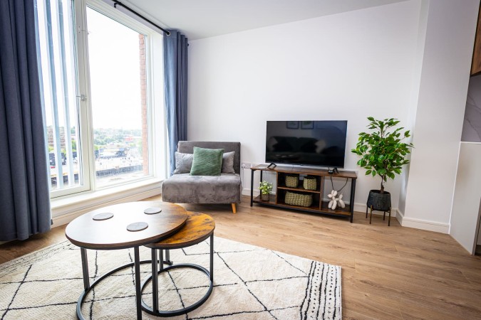 Modern Airbnb living room with coffee table and natural light.