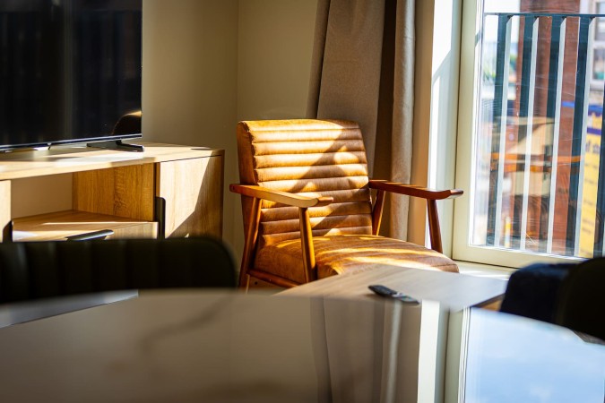 Morning light shining on a comfortable chair in an Airbnb interior.