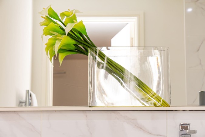 Decorative flower arrangement in glass vase for Airbnb interior.