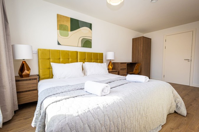 Professionally made Airbnb bed with fresh bedding and neat presentation.