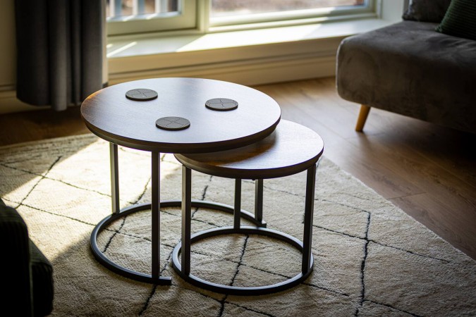 Modern Airbnb living room with coffee table on stylish rug.