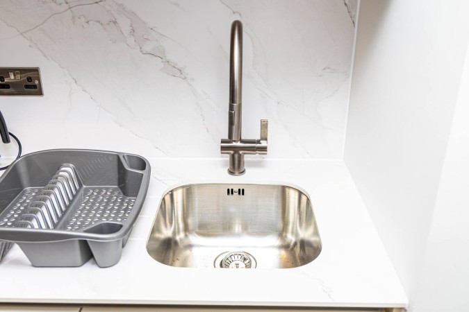 Modern Airbnb kitchen sink with sleek clean design.