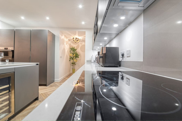 Modern Airbnb kitchen with sleek wall design and polished surfaces.
