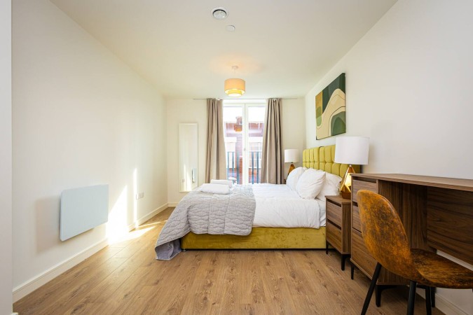 Minimalist Airbnb bedroom with stylish bed side view.