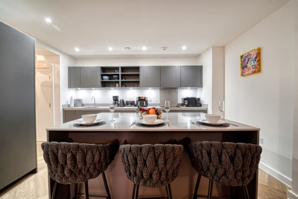 Modern Airbnb kitchen with stylish island and clean interior design.