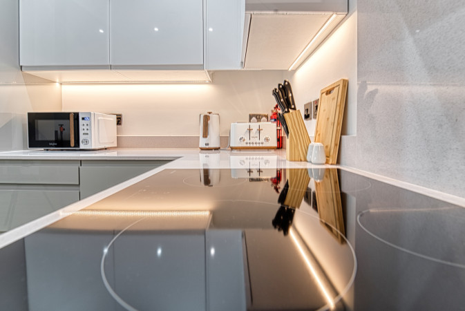 Sleek Airbnb kitchen with modern cooker and polished surfaces.